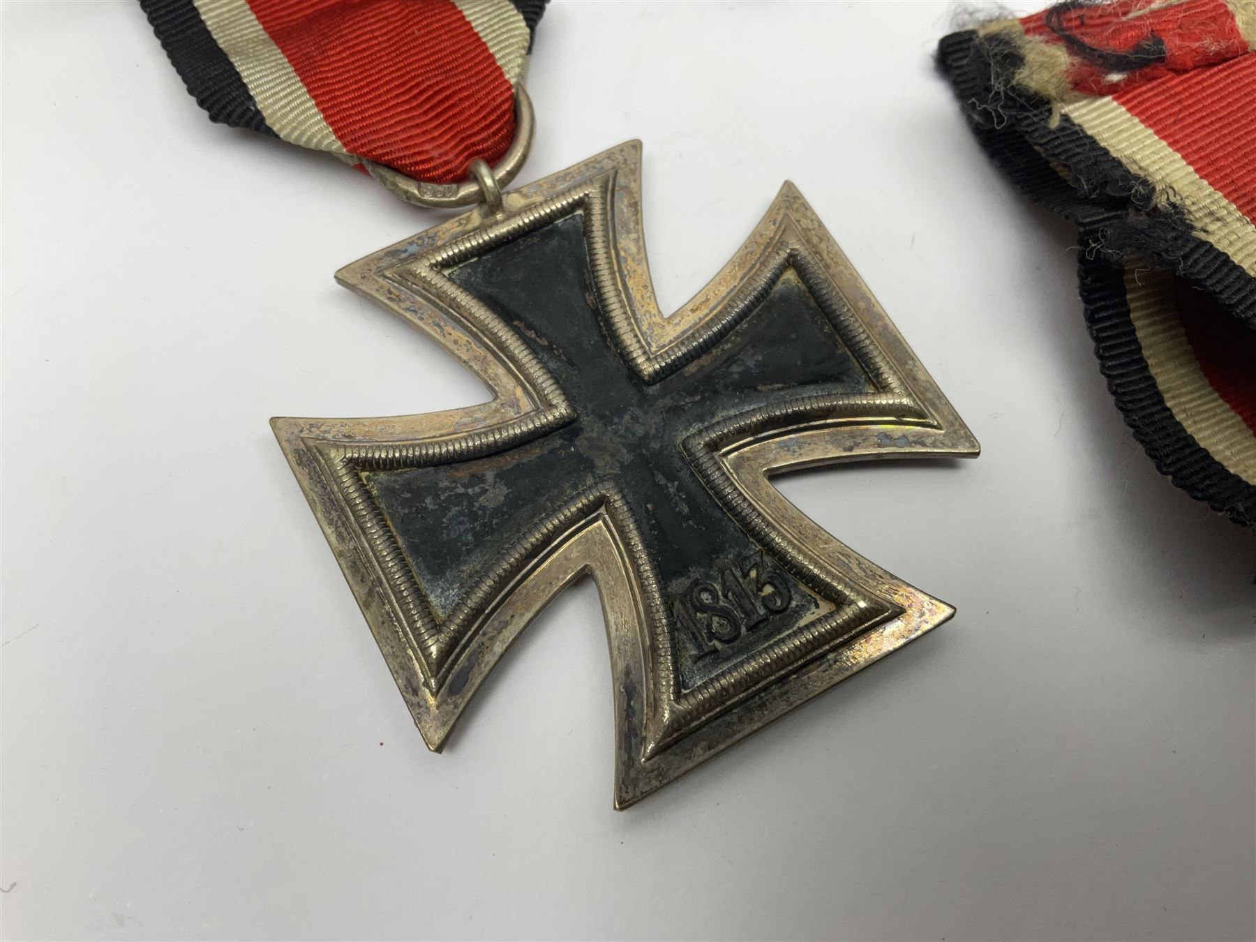 WWII German Iron Cross 2nd Class, the suspension ring stamped 128 for S. Jablonski G.m.b.H. Posen; with ribbon; together with an embroidered cloth eagle badge and quantity of German medal ribbons.
