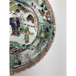 18th century Chinese bowl, decorated in the famille verte palette, of circular form with lobed edge, painted with central figural scene contained within a border of landscape panels and flowers, D27cm