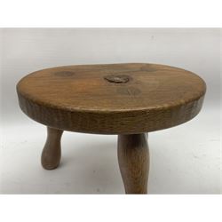 Wrenman - three-legged oak milking stool, kidney-shaped top carved with wren signature, on three splayed turned supports, by Bob Hunter, Thirlby, Thirsk