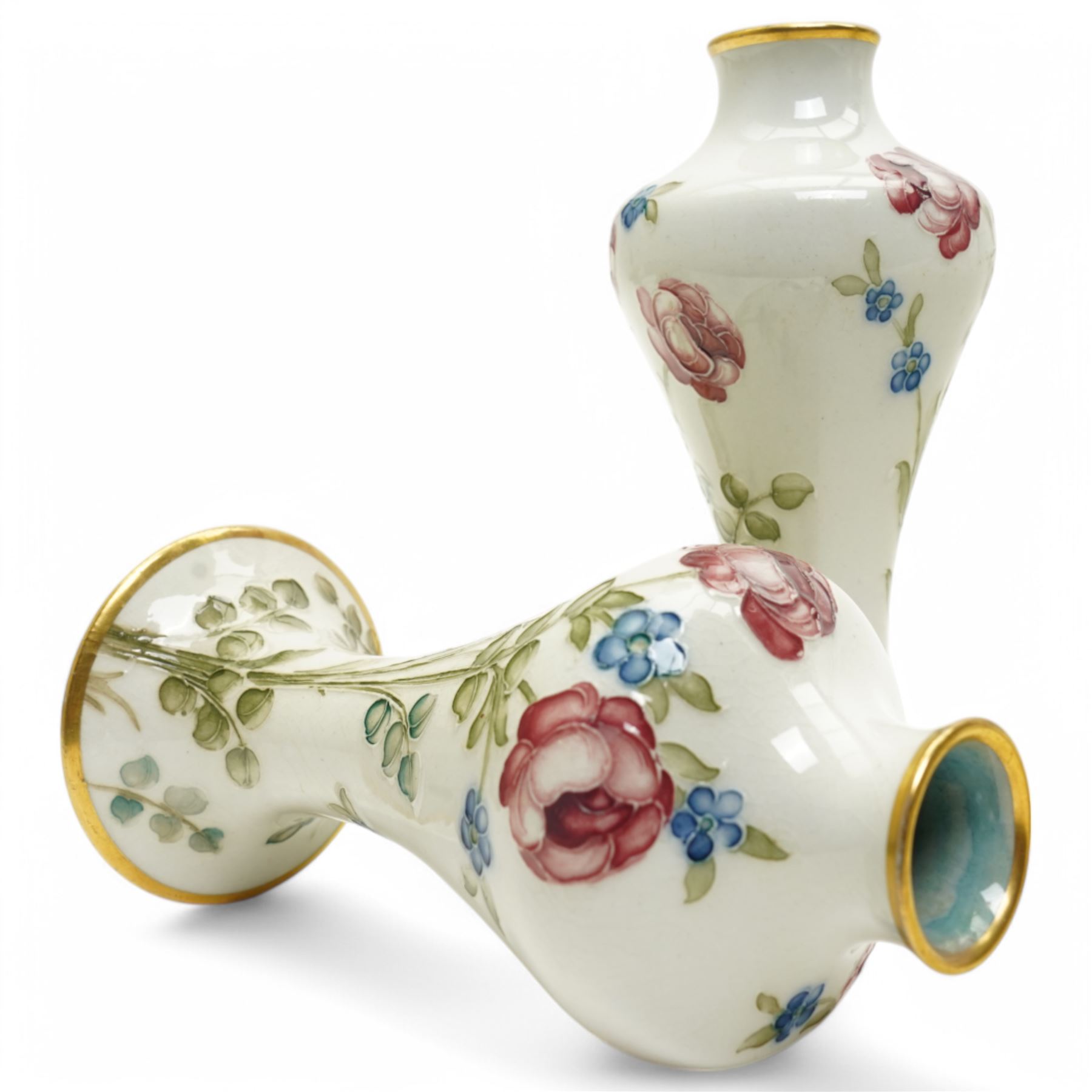 William Moorcroft for James Macintyre & Co, pair of small shouldered vases decorated with blossoming roses, burslem brown mark and Moorcroft signature to base, H15cm (2)