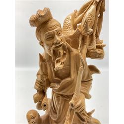 Two Japanese carved wood okimonos, to include example modelled as a fisherman holding his catch in one hand and pipe in the other, and his child, tallest H25cm