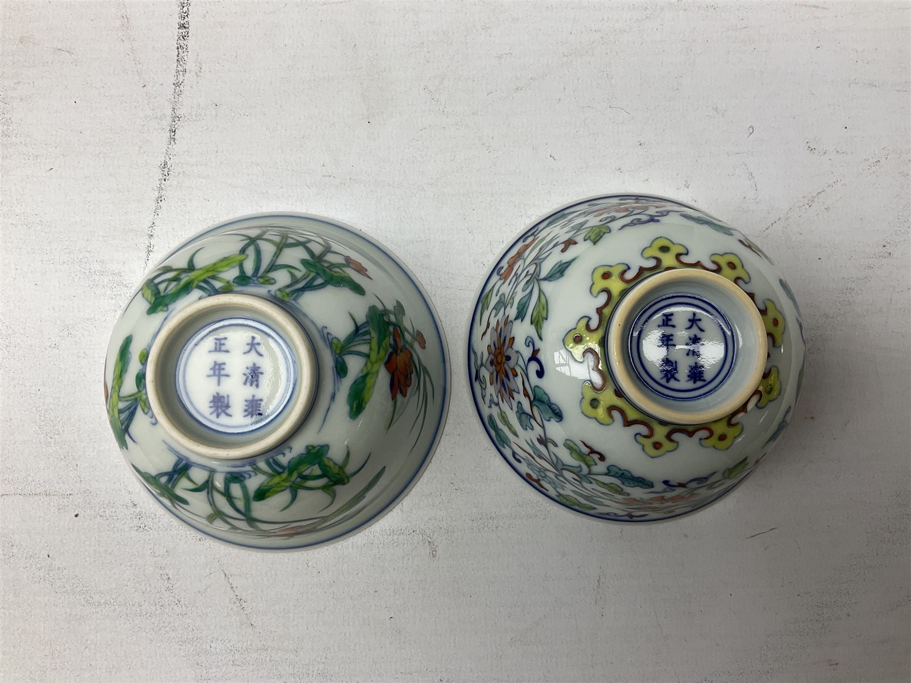 Two Chinese Yixing teapots, Chinese tea bowl hand painted with figures reading, another tea bowl with with underglaze floral panel and another tea bowl with saucer and lid, together with other teacups etc all boxed and with character marks
