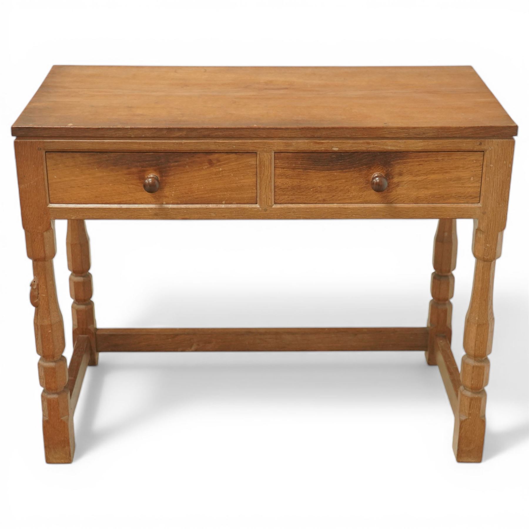 Mouseman - oak side table, rectangular adzed top, fitted with two drawers with turned wooden knobs, raised on octagonal supports, with carved mouse  signature, by the workshop of Robert Thompson of Kilburn