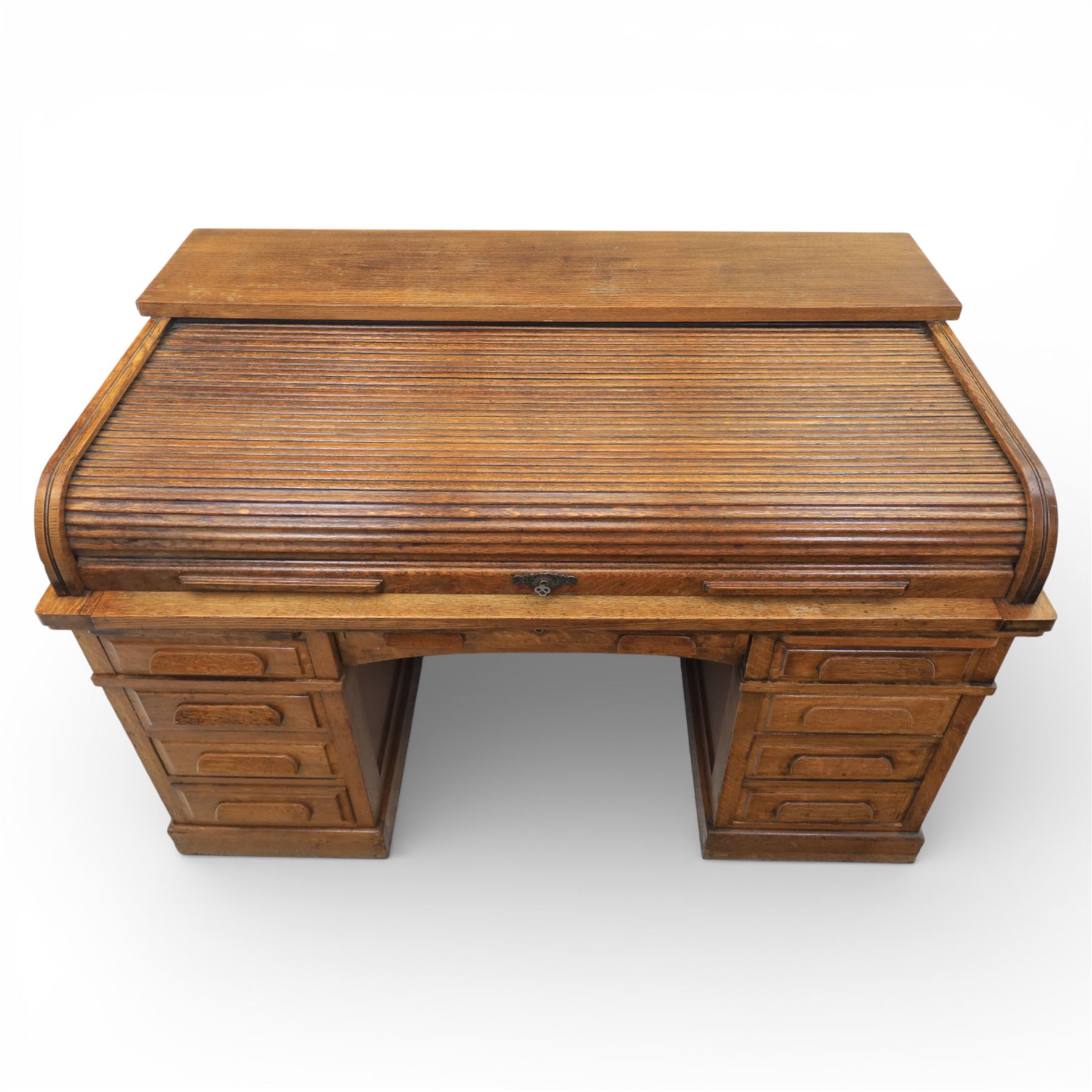Globe Wernicke - Oak roll top desk, fitted with nine drawers, oak tambour roll top revealing a fitted interior, with single frieze drawer, flanked by four drawers to each pedestal, on a plinth base