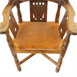 Mouseman - important oak monks chair, c1930s, the curved back inscribed with motto 'Cum Bona Voluntate Servientes' (serving with goodwill) over Trinity College Cambridge coat of arms, the shaped arms terminating with carved monks heads, each pierced side panel with Yorkshire Rose, tan leather seat on four octagonal legs joined by a cross stretcher, the back of the chair with initials ECH, with carved mouse signature, by Robert Thompson of Kilburn