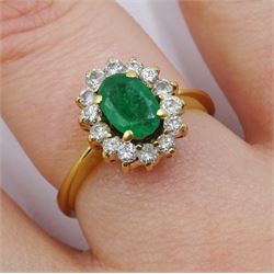 18ct gold oval emerald and diamond cluster ring, stamped
