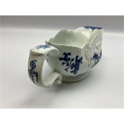 Large 18th century Lowestoft sauce boat, circa 1770, the body decorated with Hughes type floral moulding, and painted in underglaze blue with an Oriental landscape, and foliate sprigs, L23cm