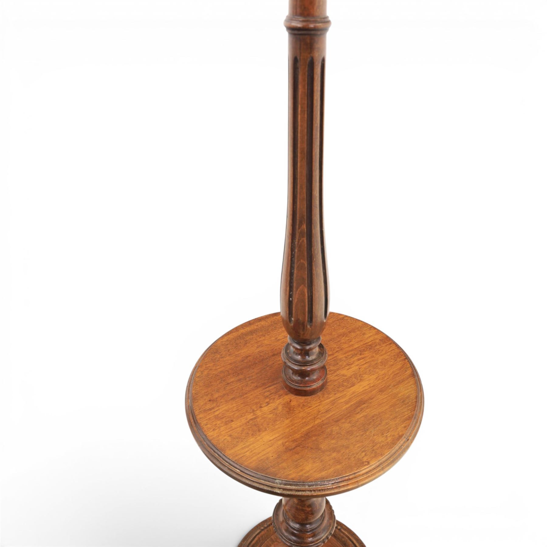 Late Victorian set of two oak standard lamps, turned and carved column supports, one with foliate carved panelled stem, on stepped square bases with carved scroll feet, the other on circular moulded spreading base