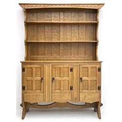 ‘Gnomeman’ adzed oak dresser, raised two heights plate rack over rectangular top, three cupboards enclosed by panelled doors each above drawer, carved linen fold uprights, shaped end supports joined by shaped pegged stretcher, carved with gnome signature, by Thomas Whittaker of Littlebeck