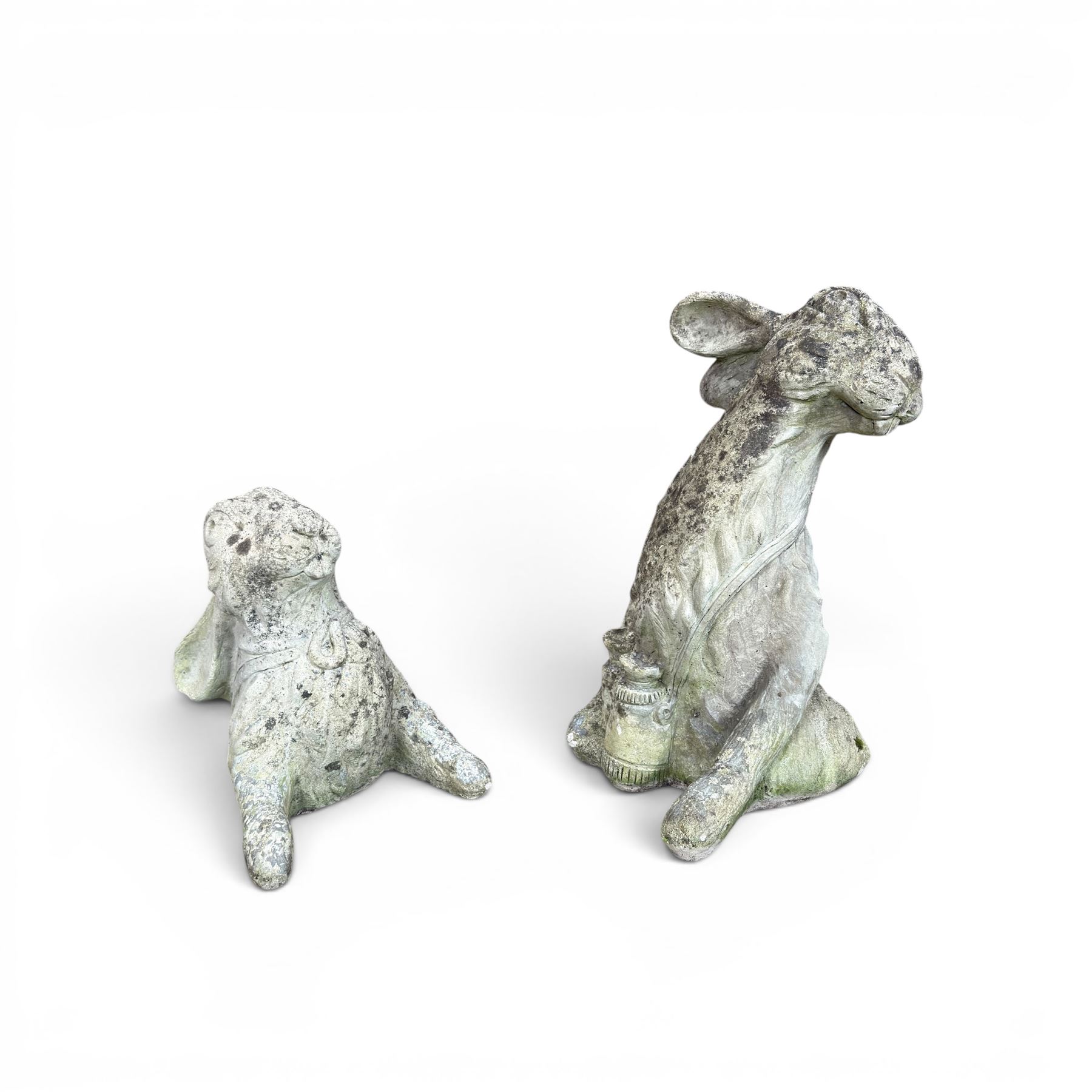 Two weathered cast stone garden hares