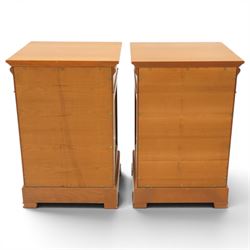 St Michael - pair of cherrywood bedside tables, single drawer above a fielded panel door, brass pulls, raised on a plinth base