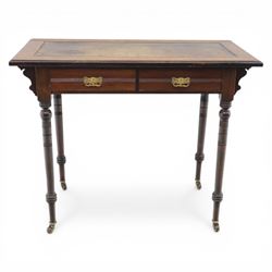Edwardian mahogany writing table, tooled leather top over two frieze drawers, on turned supports terminating in castors