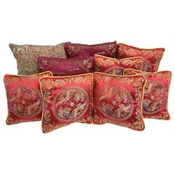 Collection of predominantly Chinese style cushions, to include feather down examples