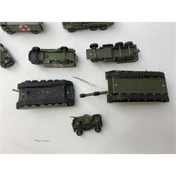 Twenty unboxed and playworn die-cast military vehicles predominantly by Dinky including tank transporters, tanks, lorries, field guns, jeeps, ambulances etc