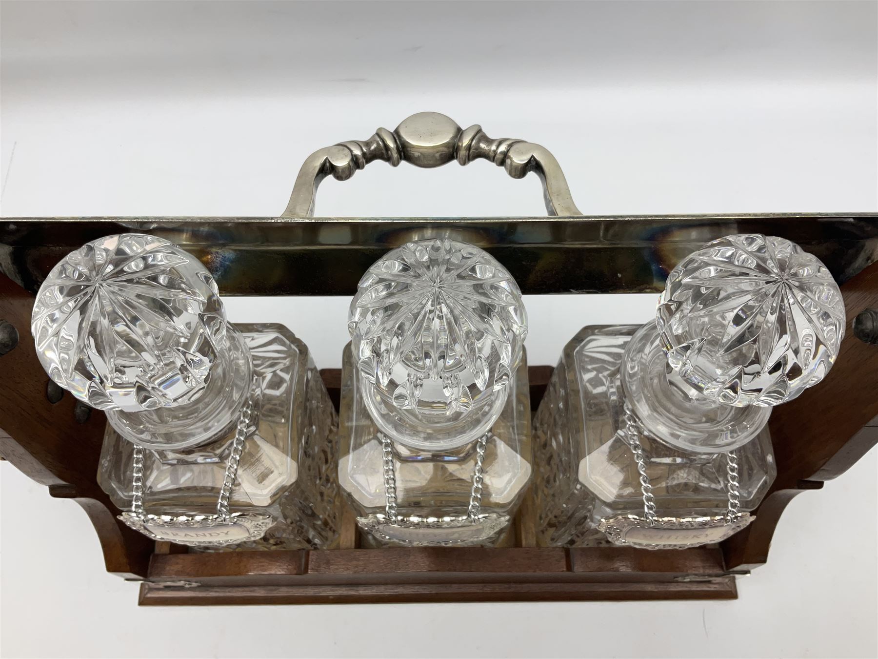 Edwardian silver plate mounted oak tantalus, containing three square sided cut glass decanters, complete with key, H33cm