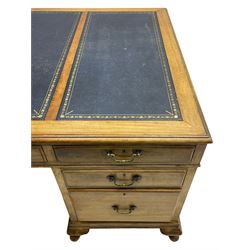 Early 20th century mahogany twin pedestal desk, the moulded rectangular top with three sectional leather insets with gilt decoration, fitted with eight drawers, on cabriole feet