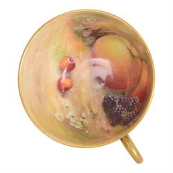 Royal Worcester fruit painted cabinet teacup and saucer, interior hand painted with apples, blackberry and cherries upon a mossy ground, the cup exterior and centre of saucer gilded, cup and saucer signed Rickells, each with puce coloured printed marks beneath, H7cm