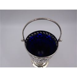 Edwardian silver swing handled sugar basket, with pierced and engraved star and foliate decoration to body, with beaded rim and handle, upon stepped circular base, hallmarked Thomas Hayes, Birmingham 1902, not including handle H10.8cm, with blue glass liner