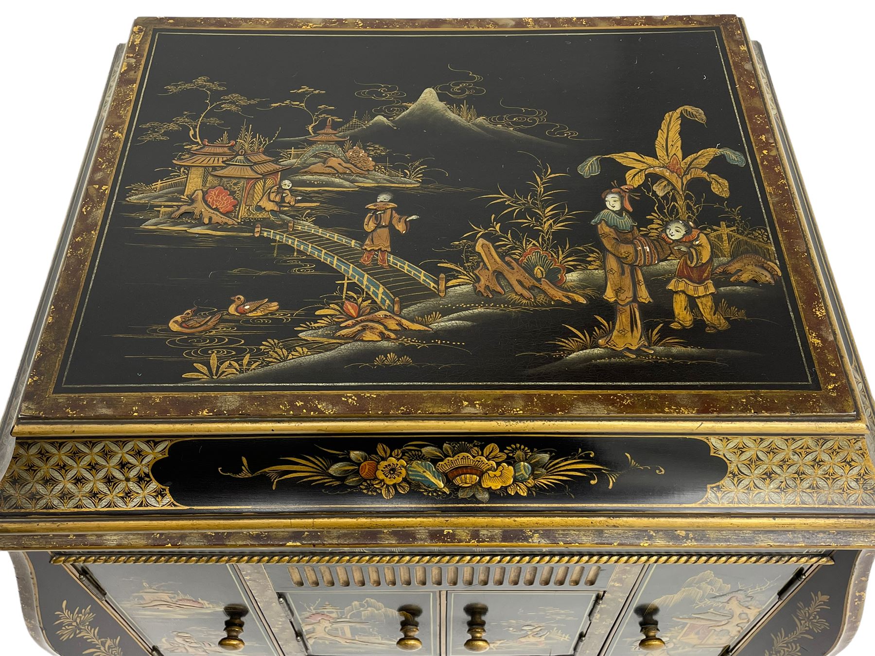 Early 20th century Chinoiserie lacquered gramophone cabinet, the lid decorated with raised gilt work, traditional landscape and figural scenes, fitted with 'Apollo' 'No. 114' gramophone, cupboards below, on cabriole supports