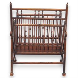 Arts and Crafts mahogany magazine stand, in the manner of Christopher Dresser, folding magazine stand, rectangular divided slatted compartments with turned spindle galleries and ball finials, the sides forming an X-frame action, raised on turned supports united by stretchers