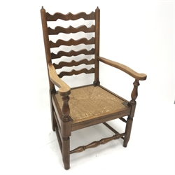 Early 20th century oak fireside armchair, shaped ladder back, reeded drop in seat, turned supports joined by stretchers, W59cm
