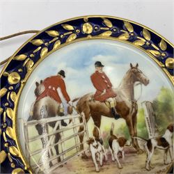 Pair of Royal Crown Derby miniature plaques, circa 1954-1955, of circular form, centrally painted with fox hunting scenes, within gilt husk and cobalt blue border, D8cm