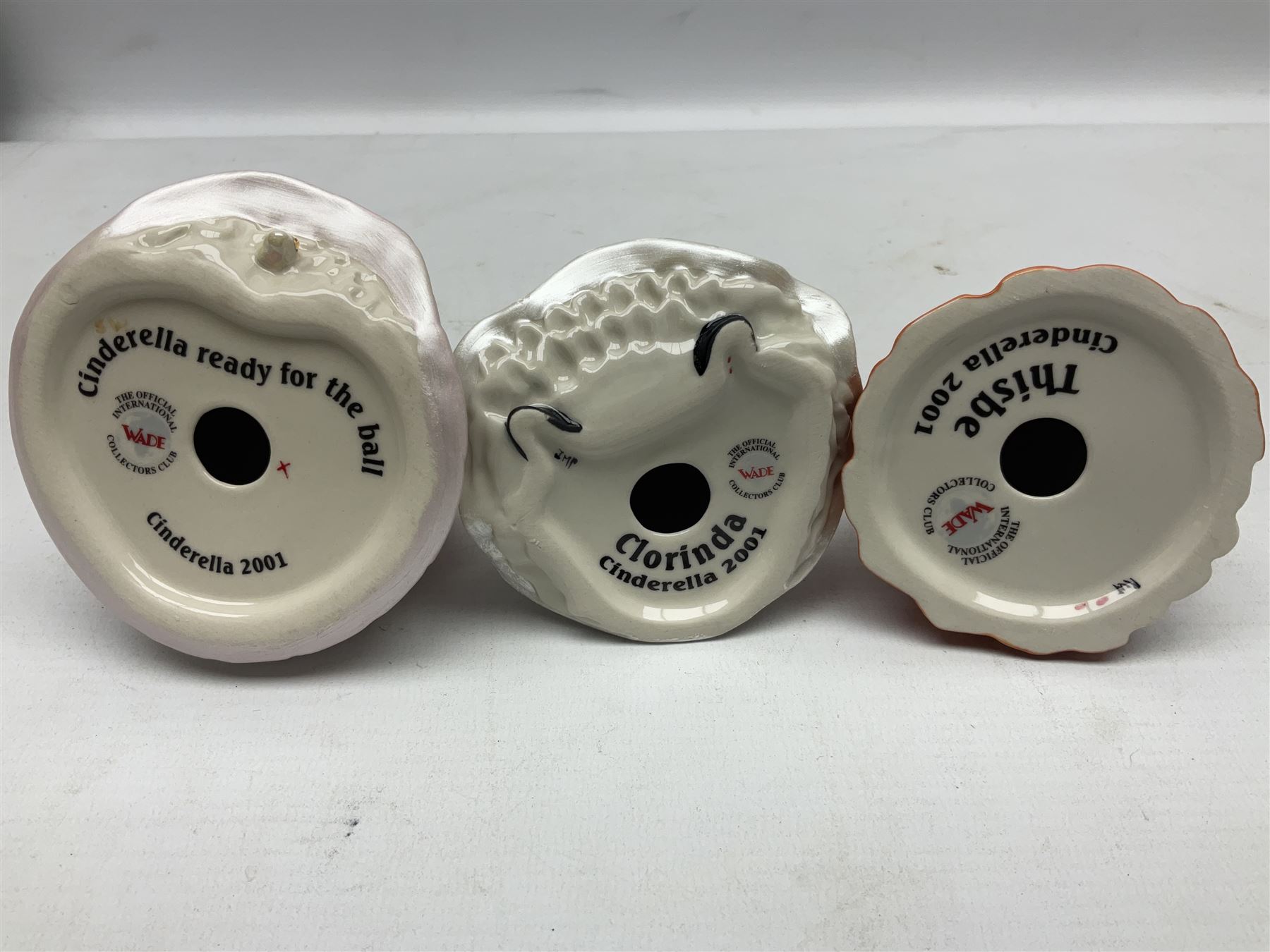 Thirteen Wade Collectors Club figures, comprising six Alice in Wonderland figures; Queen of Hearts, Alice, Mad Hatter, The Doormouse, White Rabbit and Cheshire cat, six Cinderella figures; Fairy Godmother, Cinderella Ready for the Ball, Prince Charming, Cinderella, Clorinda and Thisbe, together with Beauty from Beauty and the Beast, all with original boxes  