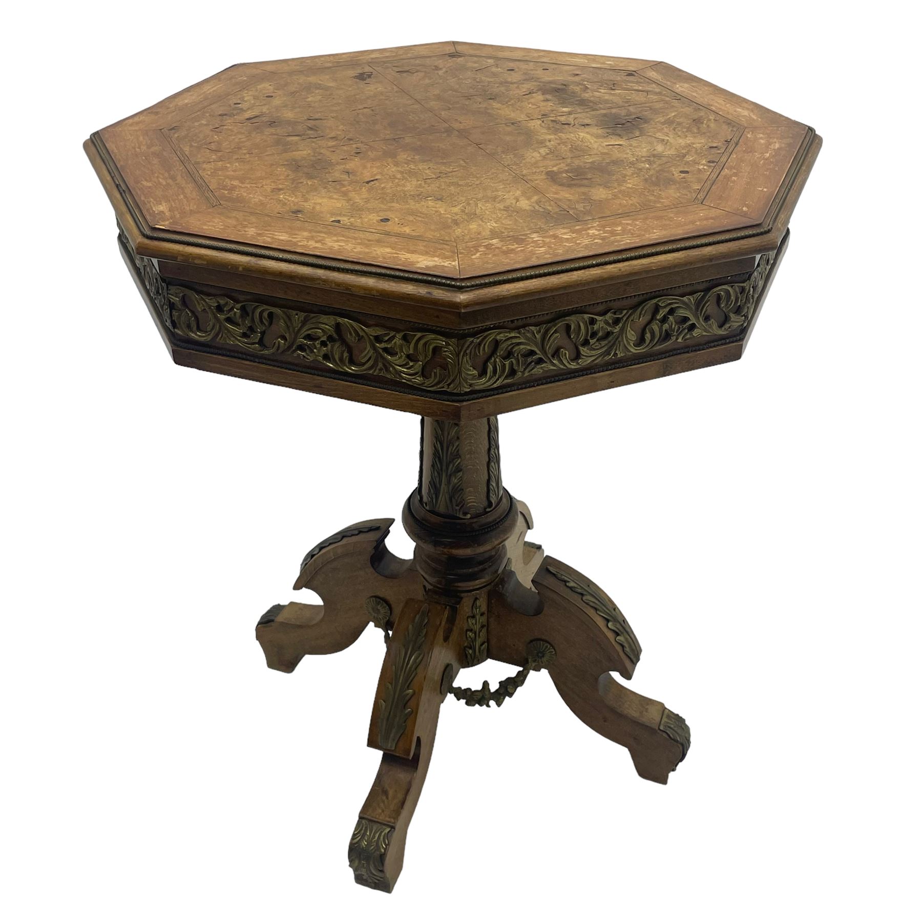 Mid-20th century figured walnut Italian design centre table, octagonal quarter veneered top with cross banding and moulded edge, the skirt decorated with scrolling foliage gilt metal mounts, on turned pedestal mounted with gilt acanthus leaves, quadruple splayed supports with further acanthus leaf decoration