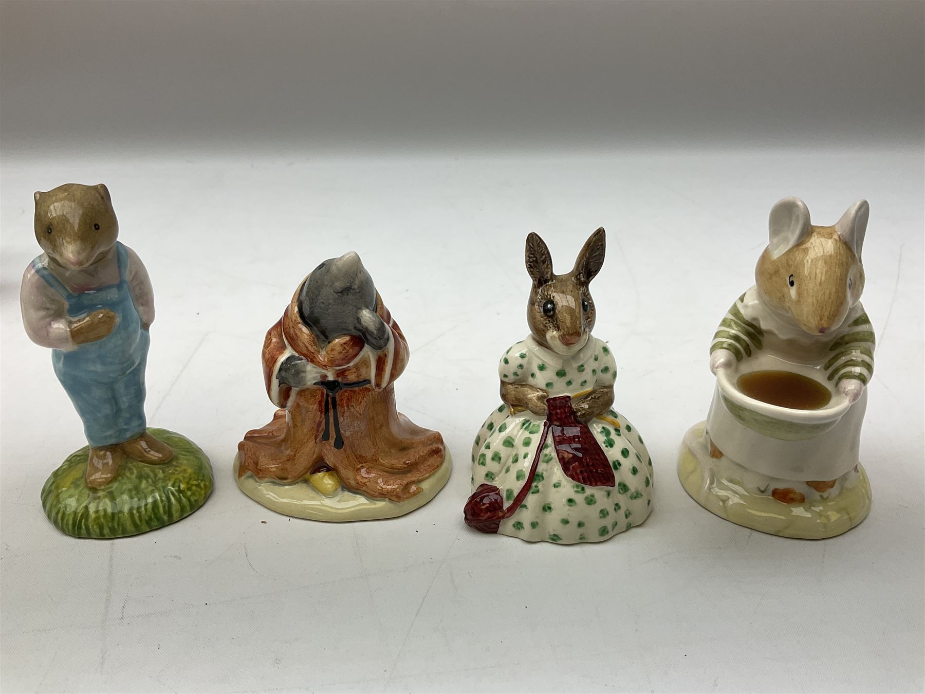 Fifteen Royal Doulton Brambly Hedge figures, comprising Wilfred Toadflax, Dusty Dogwood, Mrs Toadflax, Mr Apple, Primrose Woodmouse, Lord Woodmouse, Poppy Everbright, two Lady Woodmouse, two Old Mrs Everbright, Mr Toadflax, Mrs Apple, Santa Bunnykins and Bunnykins, together with three Royal Albert Wind in the Willows figures comprising Ratty, Badger and Mole, all with printed marks beneath (18)
