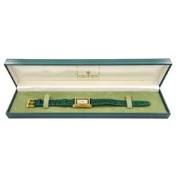 Gucci ladies gold-plated quartz wristwatch, Ref. 2600 L, silvered and green dial, on original green leather strap with gilt buckle, boxed