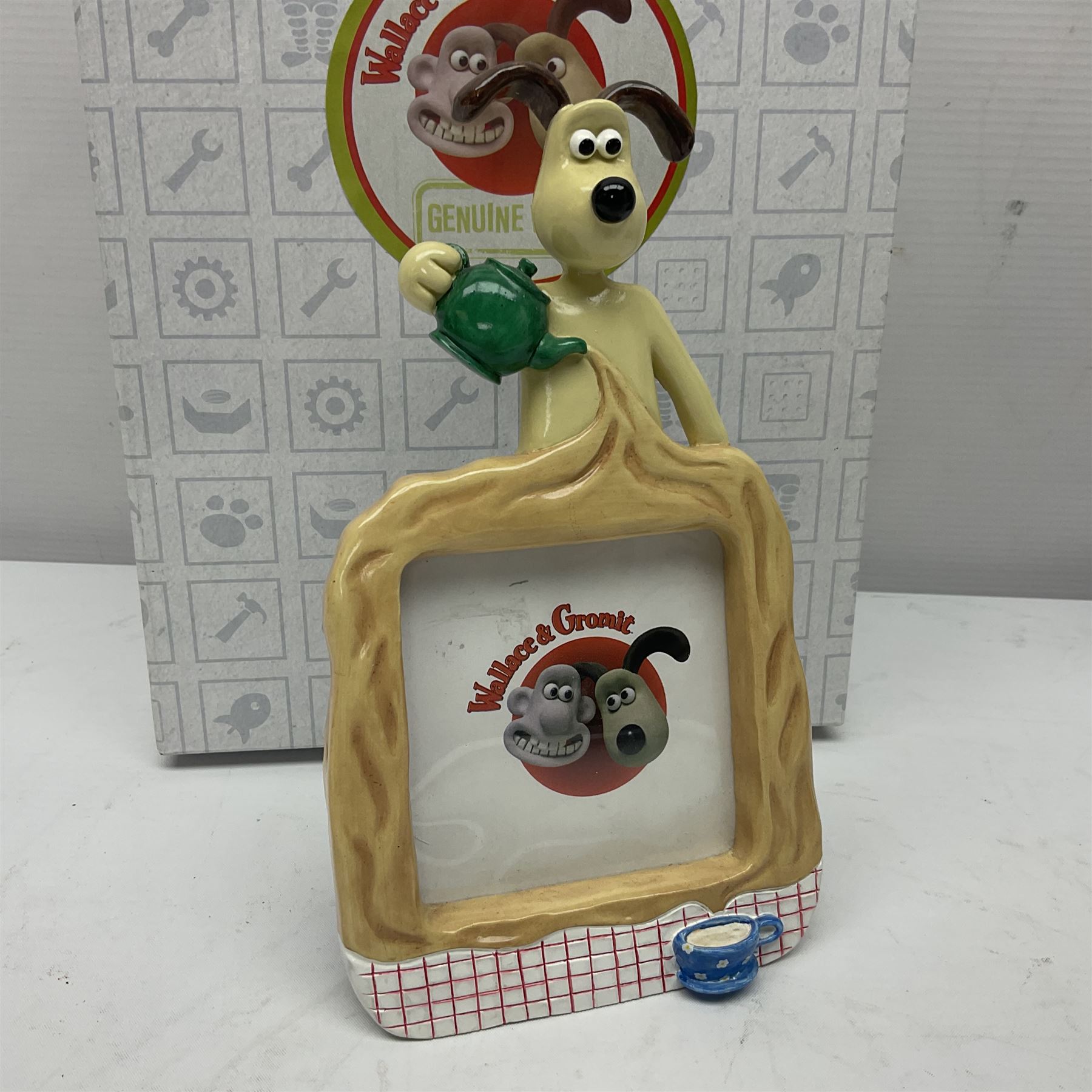 Border Fine Arts Shaun The Sheep Tractor Train and musical figure, together with a Wallace and Gromit photograph frame and a Gromit cruet sett, three in original boxes  