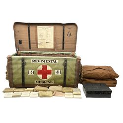 WW2 British Army RAMC 'Regimental Medical Pannier', well marked externally and dated 1941, stamped May 1943 internally, canvas covered wicker form with leather edges, hinged top and fall front with two rope carrying handles, fitted iron locking straps with securing chains; contains various unused field dressings and bandages with WW2 dates and two pillows; original label under lid L79cm