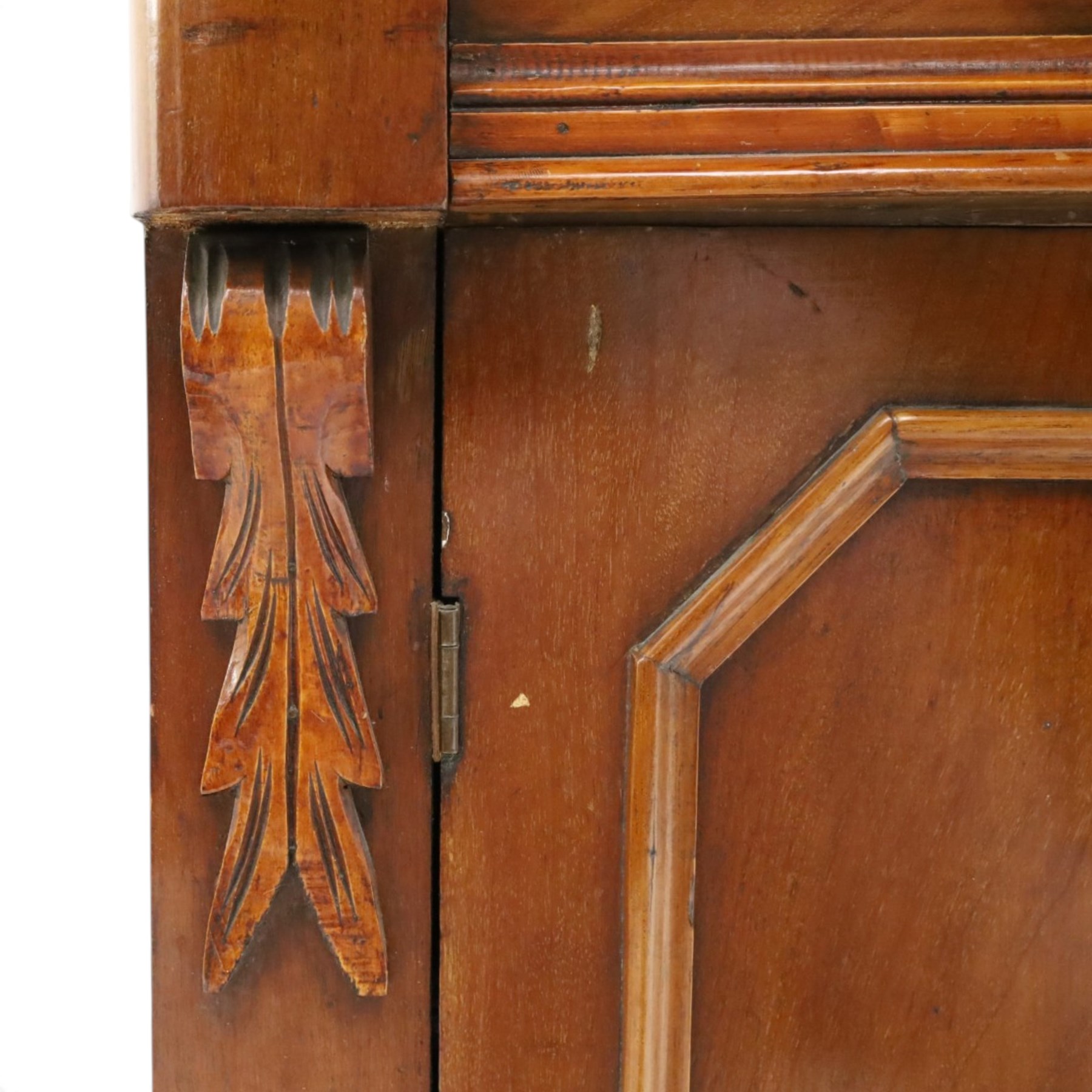 Victorian mahogany bookcase on cupboard of slender proportions, projecting cornice over dentil-frieze, fitted with twin-glazed doors enclosing three shelves, flanked by acanthus corbels, the base fitted with single frieze drawer over panelled cupboard, on skirted base
