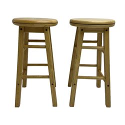 Two light oak bar stools with swivel tops