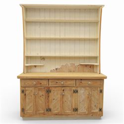 Late 20th century pine and white painted dresser, the upper section with three shelves and boarded back, upon a base with three drawers with knob handles and three panelled cupboard doors, on a raised sled base