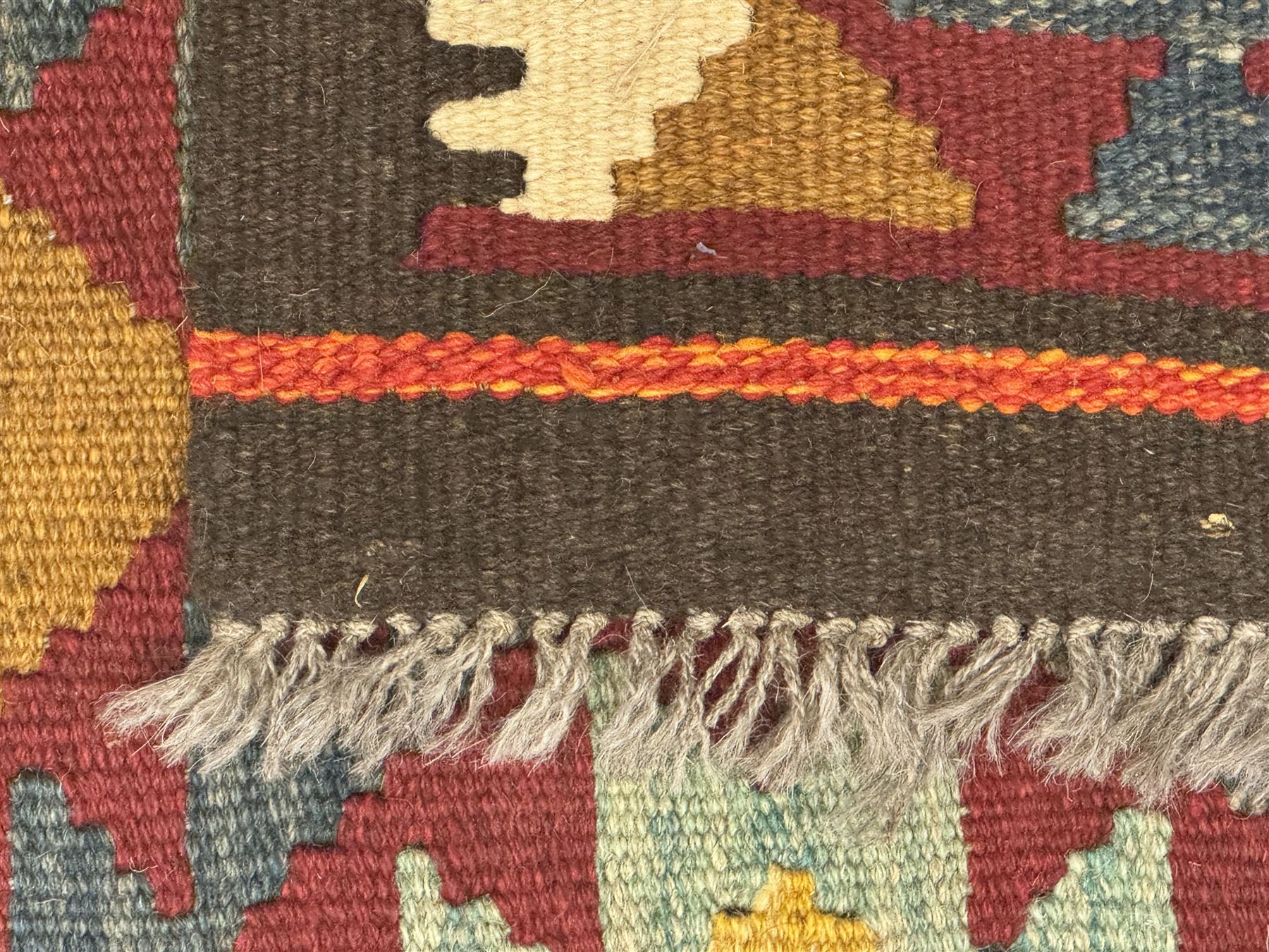 Maimana Kilim ground runner, multicoloured geometric medallions arranged in rows, with triangular motifs in the field, the wide border in brown with contrasting guard bands