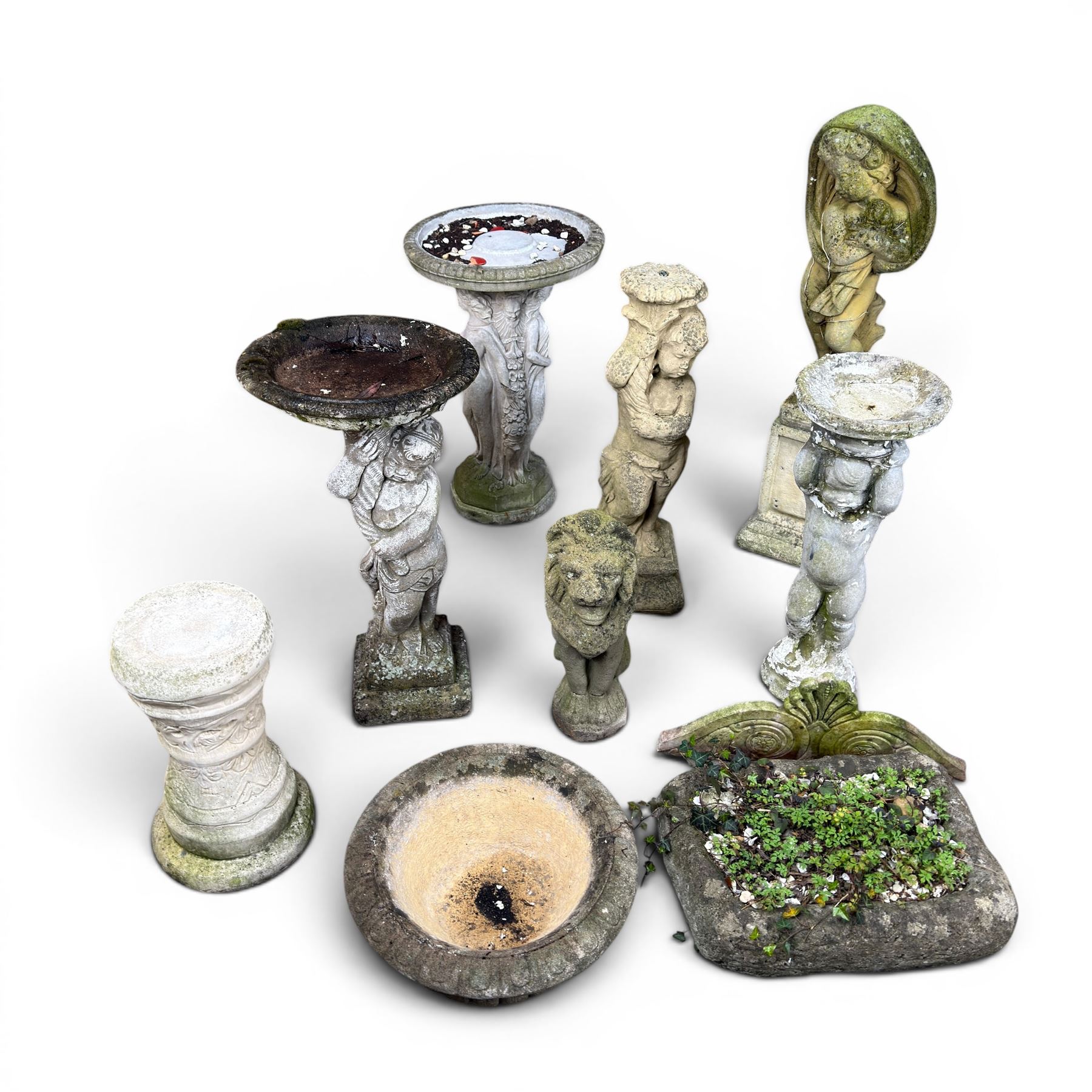 Collection of cast stone garden ornaments - three figure bird baths, figure on plinth, seated lion, lion, boy figure, and stone trough (9)