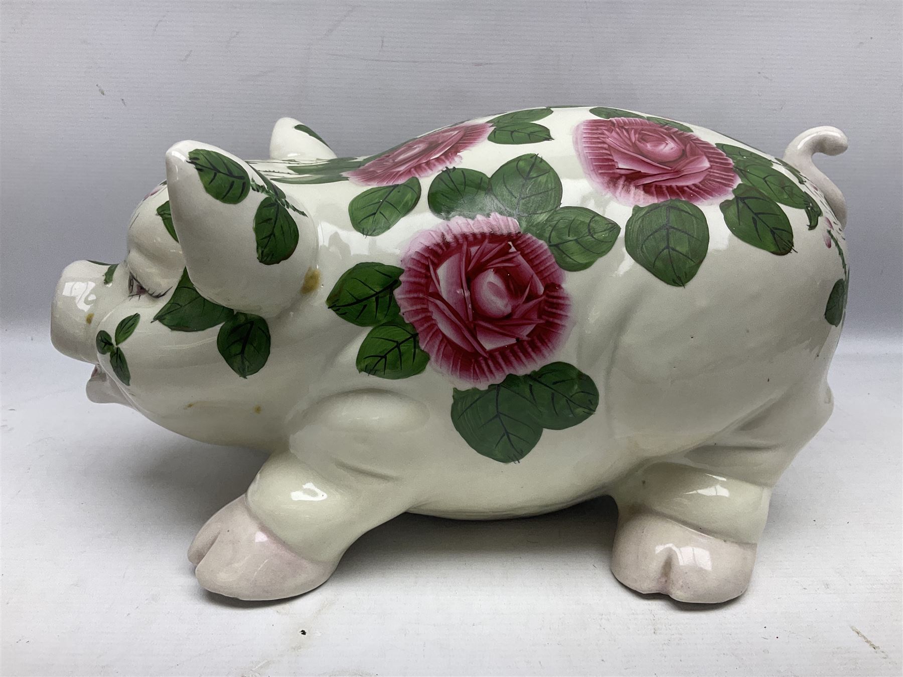 Large ceramic figure of a pig decorated with roses, L45cm