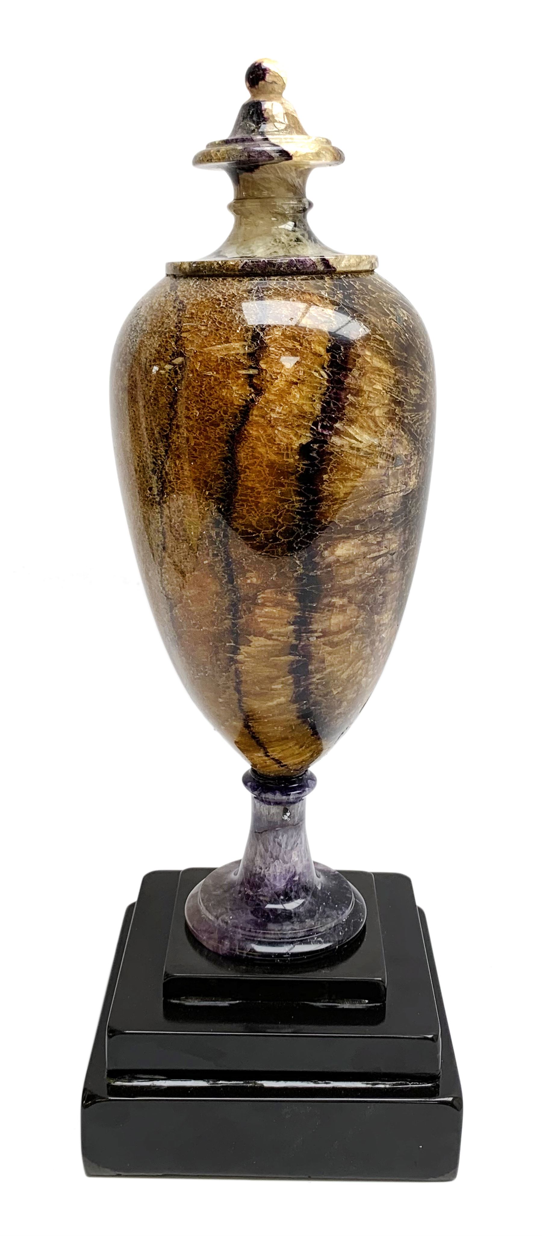 Early 19th century and later Blue John urn, Winnats one vein, of ovoid form with integrated cover and ball finial, upon a spreading circular base, and square stepped black lacquered base, H34.5cm
