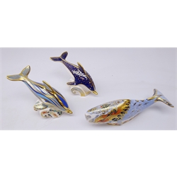  Three Royal Crown Derby paperweights: Oceanic Whale designed exclusively for the Royal Crown Derby Collectors Guild dated 2004, L22cm, Striped Dolphin, gold stopper and another Dolphin, silver stopper (3)  
