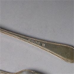 Victorian silver spoon and fork set, each with bead rim and engraved monogram and a silver spoon with scroll handle, with bright cut engraving to underside of bowl, all hallmarked 
