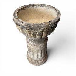 20th century good quality weathered cast stone pedestal urn of ecclesiastical design, circular lobed bowl with rope twist and lattice border, raised on squat base with fluted column  and acanthus decorated base