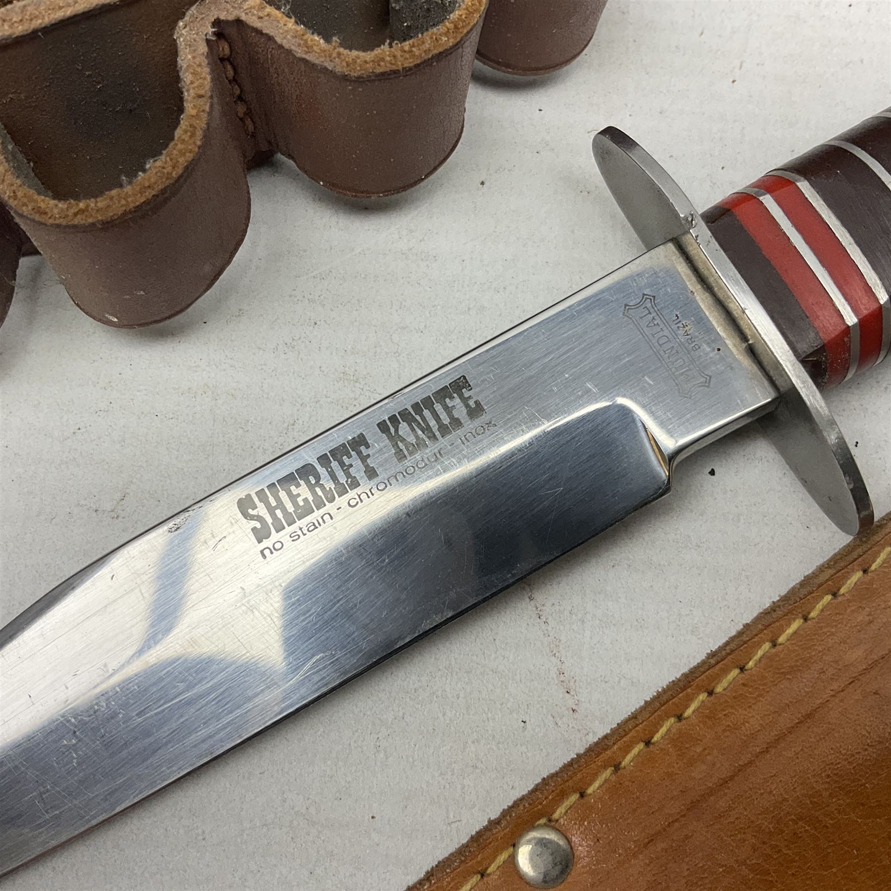 Mundial Brazil bowie knife, the 15.5cm steel blade inscribed 'Sheriff Knife', with banded and aluminium hilt; in leather sheath L29cm overall; British Army felt covered metal water bottle with webbing strap; leather 12-bore cartridge belt; and small pair of non-military binoculars in part case (4)