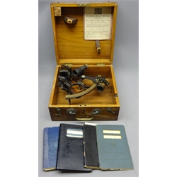  Mid 20th Marine Sextant, black crackle frame with brass scale arc inscribed D Shackman & Sons of London, No 3554, with index  and horizon mirrors and detachable eyepiece, the fitted travel case with certificate dated 21st August 1944, L24cm max, with Seaman's Record & Discharge books for C E Houghton and two Distance and Bearing Tables (5)  