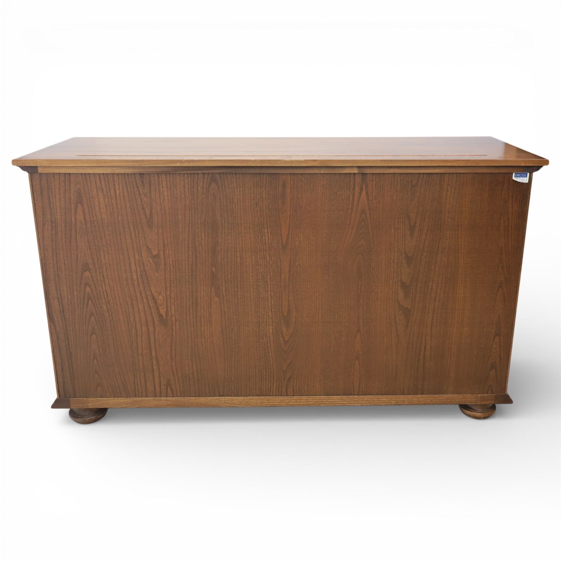 Ercol - elm dresser sideboard, fitted with four drawers and four cupboards with carved detail, drawer featuring cutlery slide