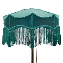 Art Deco brass standard lamp, telescopic column with level action, ring turned collars, raised on a shaped tri-form base with fluted pad feet, complete with green fabric fringed shade