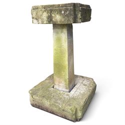 Weathered cast stone birdbath, circular bowl over a lobed baluster pedestal on circular base; weathered cast stone sundial of squared form with re-entrant corners and removable metal sundial with personified death motif
