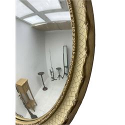 Convex wall mirror in cream and gilt finish frame