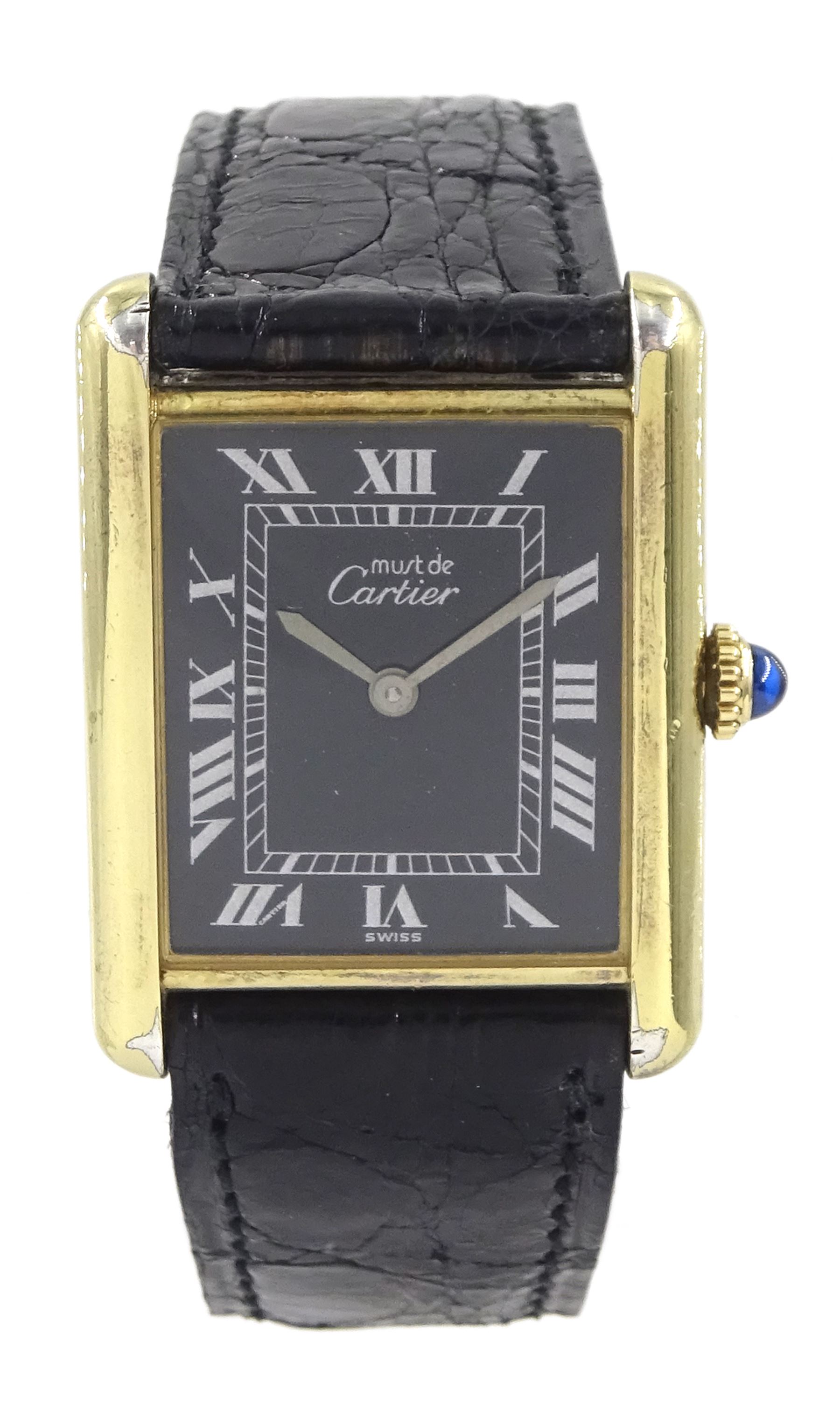 Must de Cartier Tank silver-gilt manual wind wristwatch, black dial with Roman hour markers, hallmarked, on Cartier black leather strap, with gilt buckle, boxed with service papers dated 1994