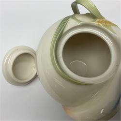 Franz Teapot decorated with dragonflies, together with a matching sucrier and cover and a cup and saucer in Iris pattern, all with printed mark beneath 